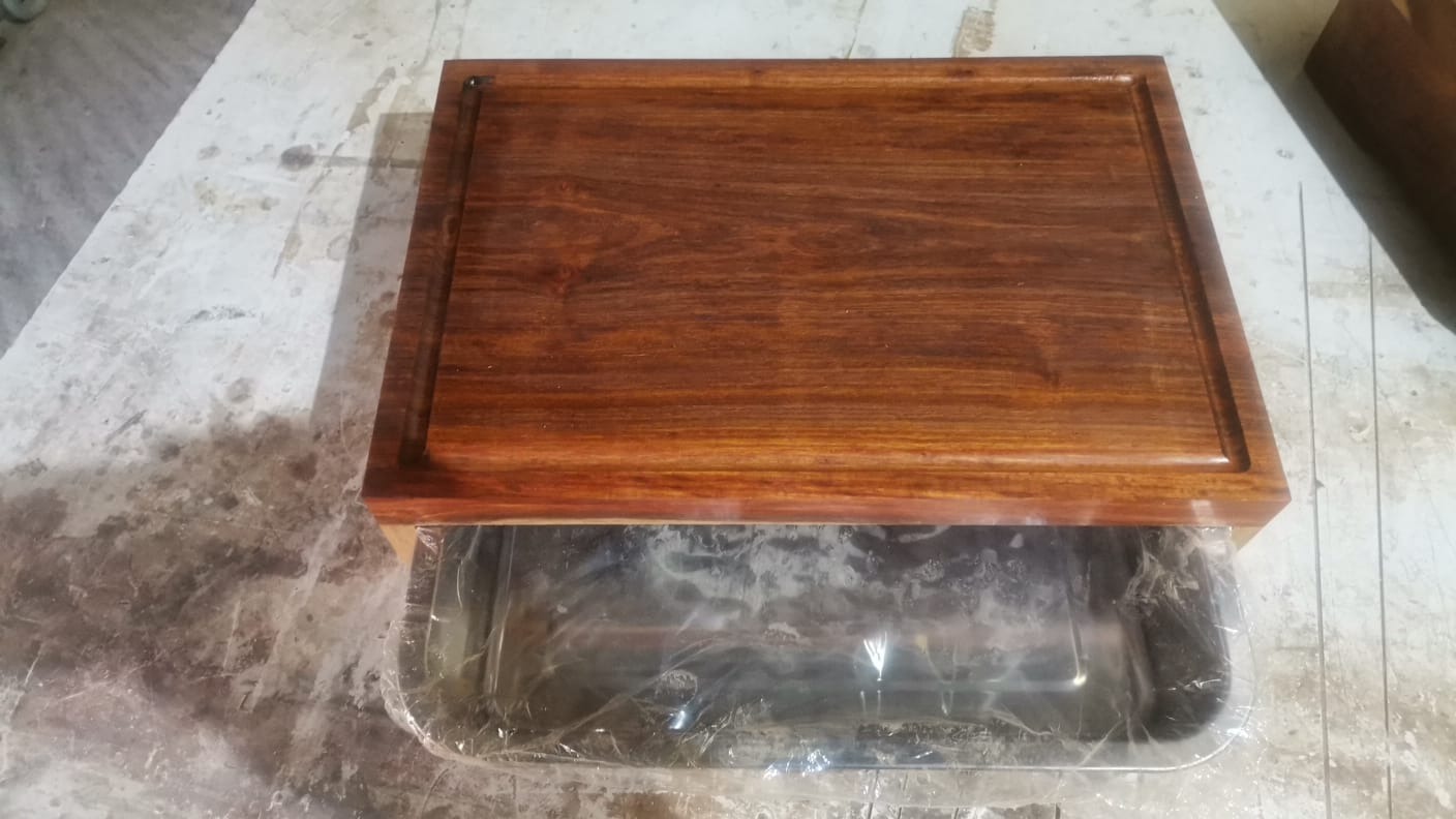 Front view of a handmade board and sliding tray at the workshop