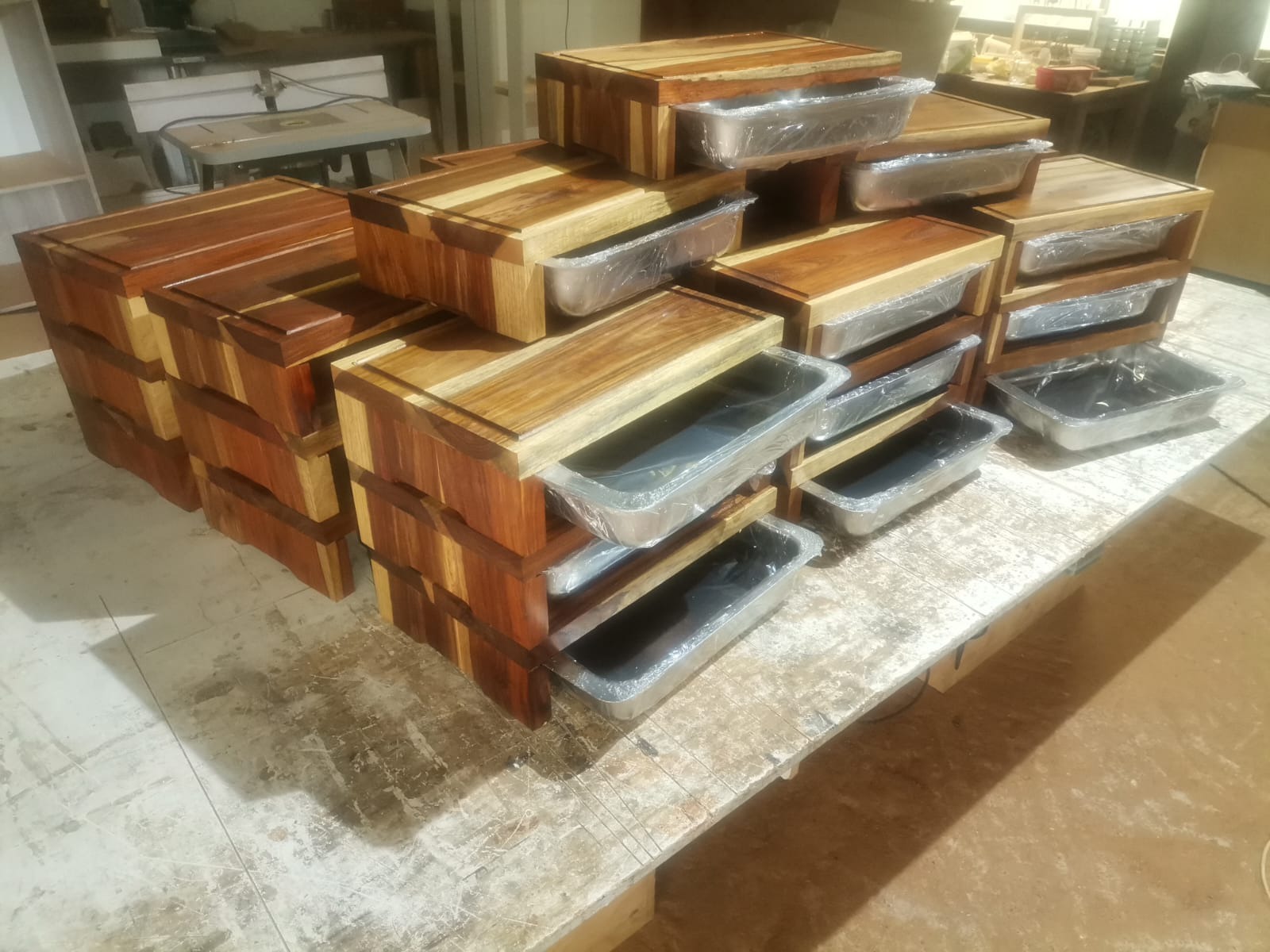 A batch of handmade Kiaat & Steel Boards in the workshop